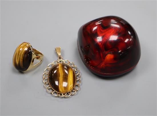 A yellow metal mounted tigers eye quartz oval pendant and a similar dress ring.